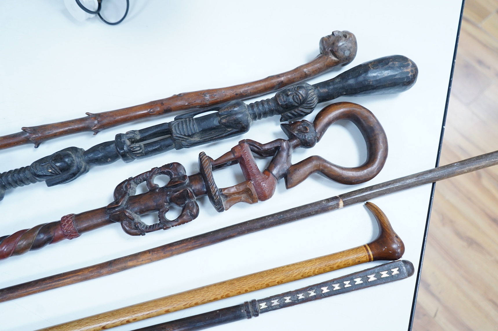 A collection of African and other walking sticks and walking canes - ebonised cane 105 cm long